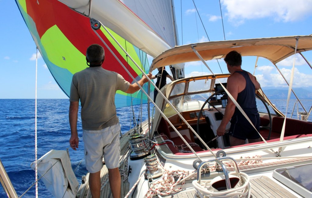 Colourful large sail (chute) up and pulling the boat.